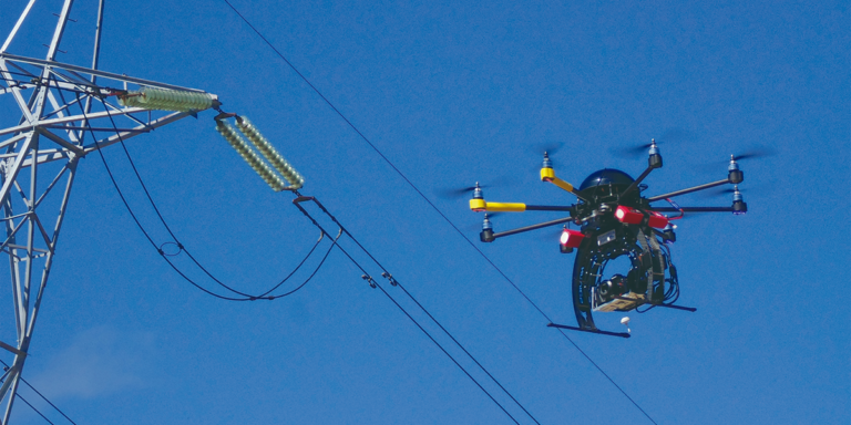 Dron volando cerca de un tendido eléctrico.